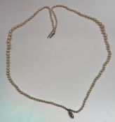 A two strand graduated pearl necklace, the navette form clasp with central small diamond (approx 0.