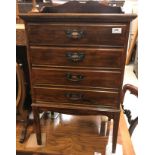 A 20th Century stained beech music chest of four drawers with fall fronts,