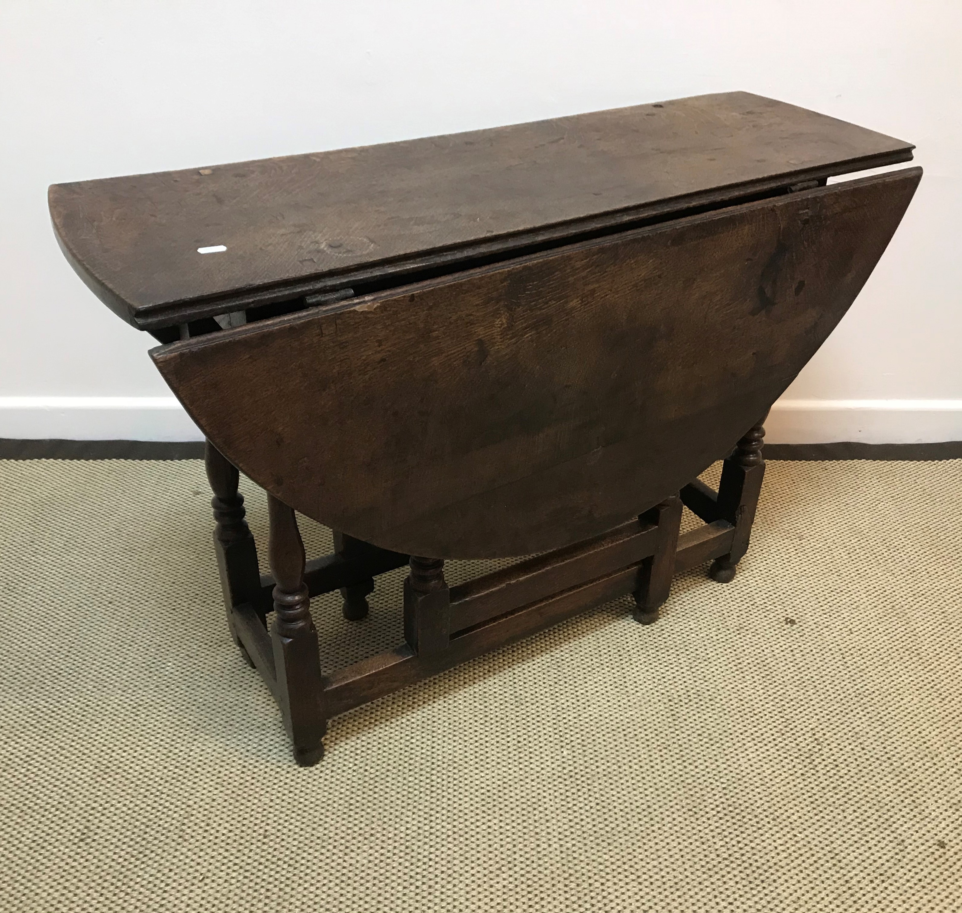 A 19th Century oak oval gateleg drop-leaf dining table of small proportions,