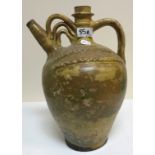 A glazed terracotta water ewer, 37 cm high and a green glazed jardinier,