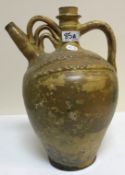 A glazed terracotta water ewer, 37 cm high and a green glazed jardinier,