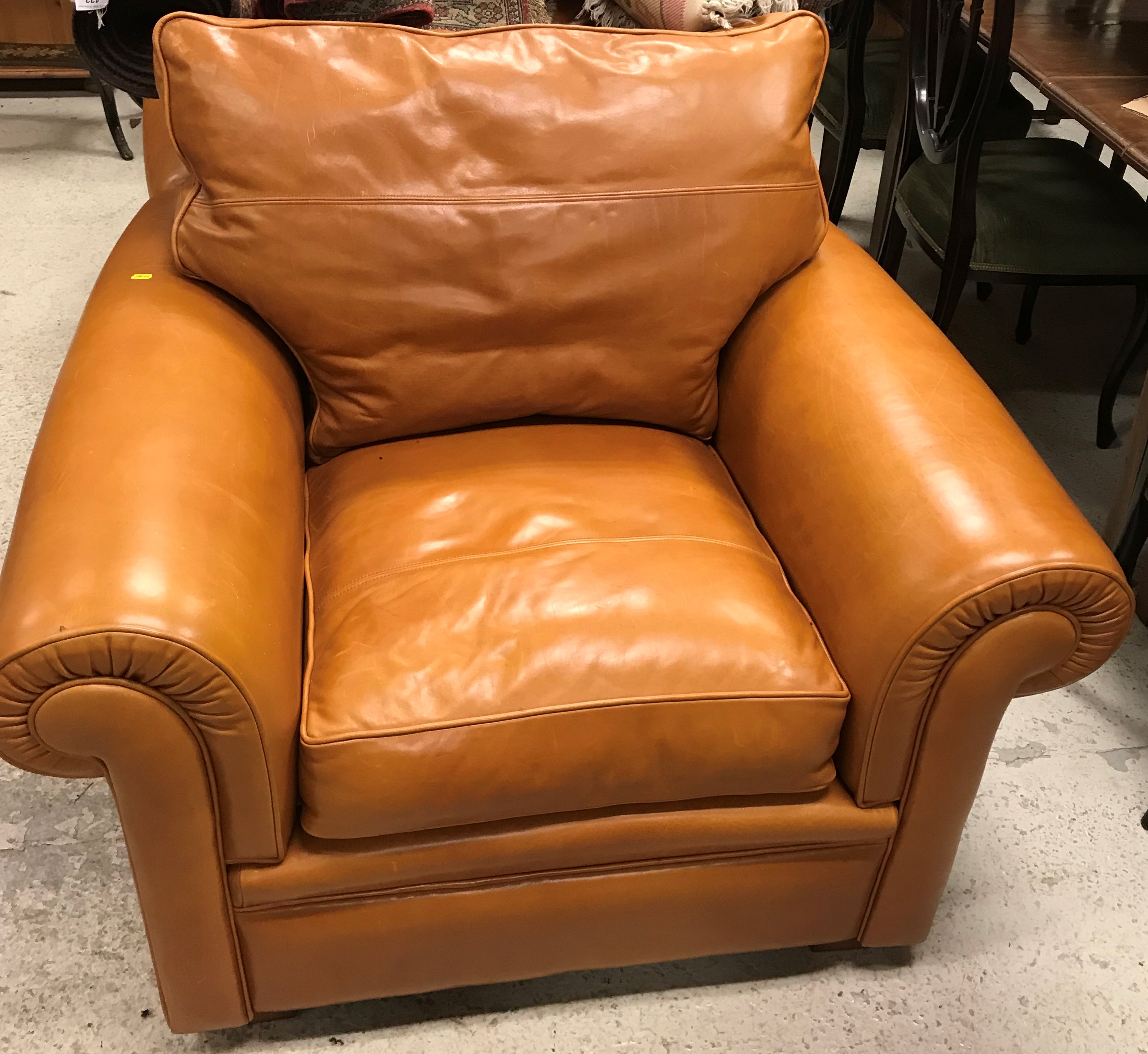 A pair of modern Duresta pale brown leather upholstered scroll-arm chairs,