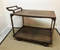 A modern teak and mother of pearl inlaid four-wheeled trolley of large proportions, 85.