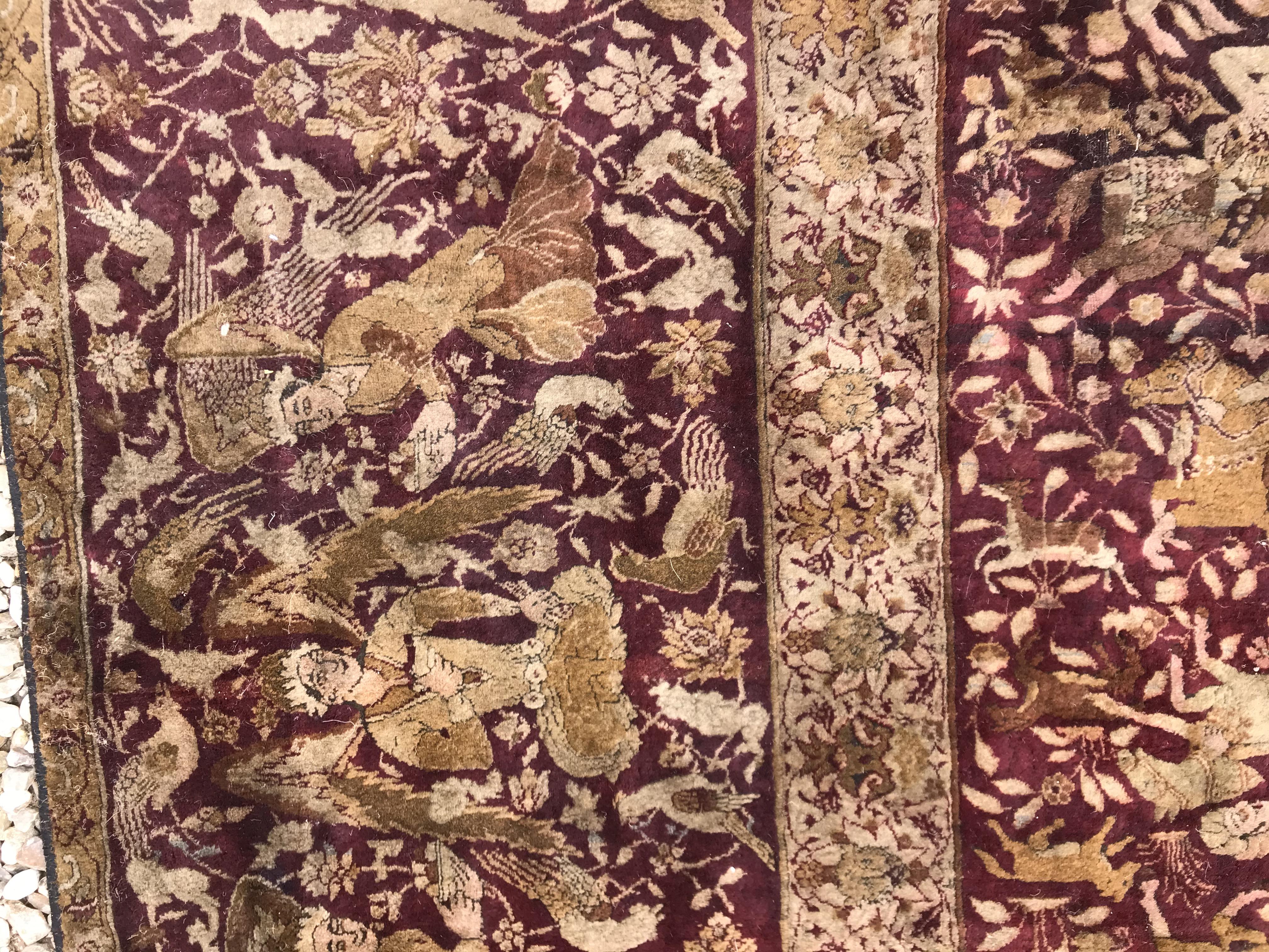 An early 20th Century Agra North India carpet with centre medallion on a wine-coloured ground, - Image 45 of 103