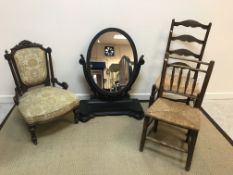 A Victorian carved walnut framed nursing chair with upholstered back panel and seat,