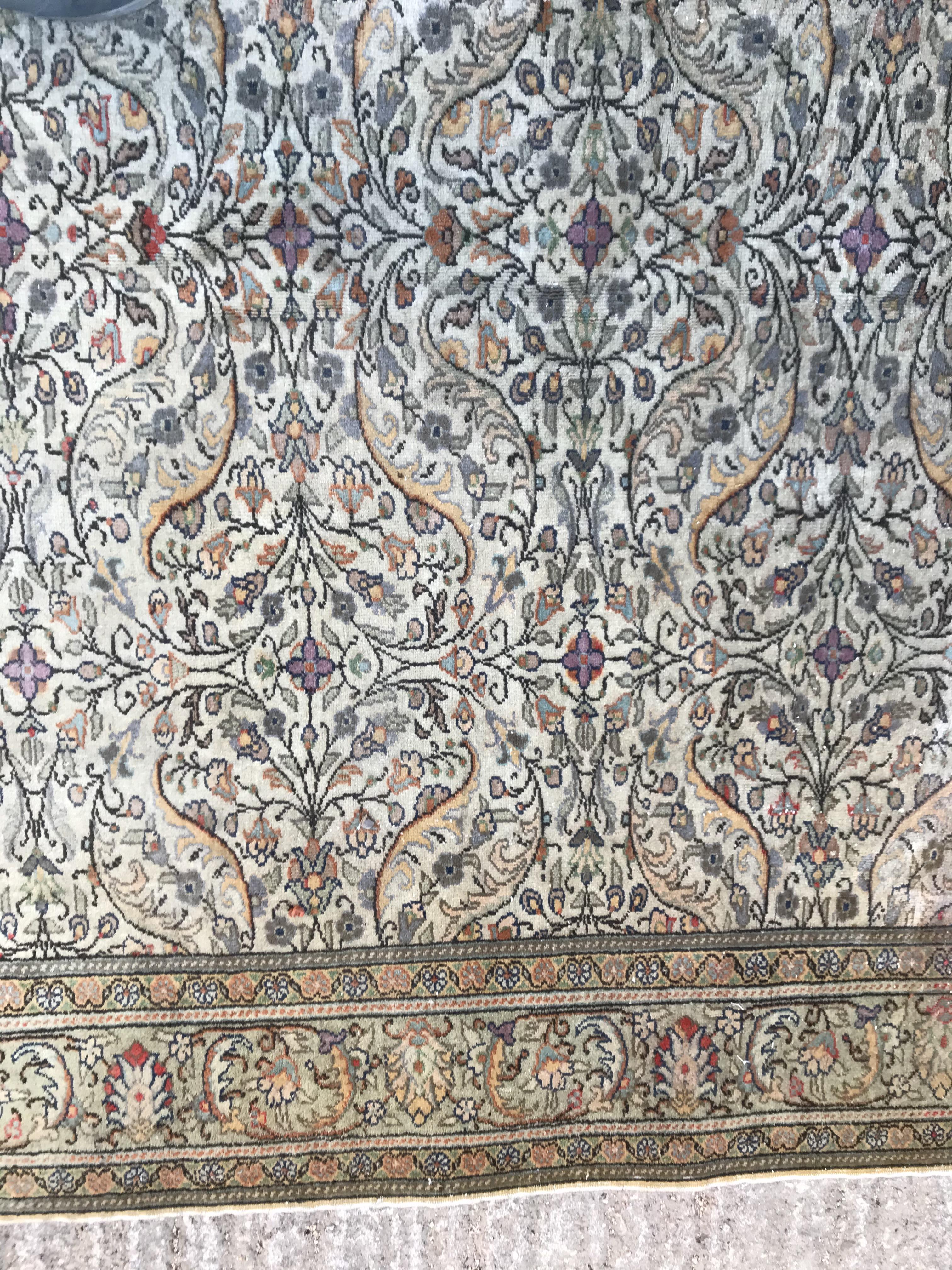 An Oriental carpet, the central panel set with all over floral decoration on a fawn ground, - Image 5 of 11