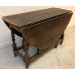 An 18th Century oak gate-leg drop-leaf dining table,