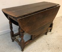 An 18th Century oak gate-leg drop-leaf dining table,