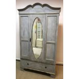 A painted and gilded single mirror door wardrobe with single drawer, raised on bracket feet,