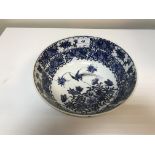 A 19th Century Chinese bowl with blue and white floral and bird decoration bearing six character