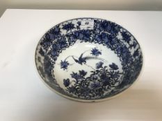 A 19th Century Chinese bowl with blue and white floral and bird decoration bearing six character