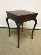 An Edwardian mahogany envelope card table, the four section top with moulded edge,