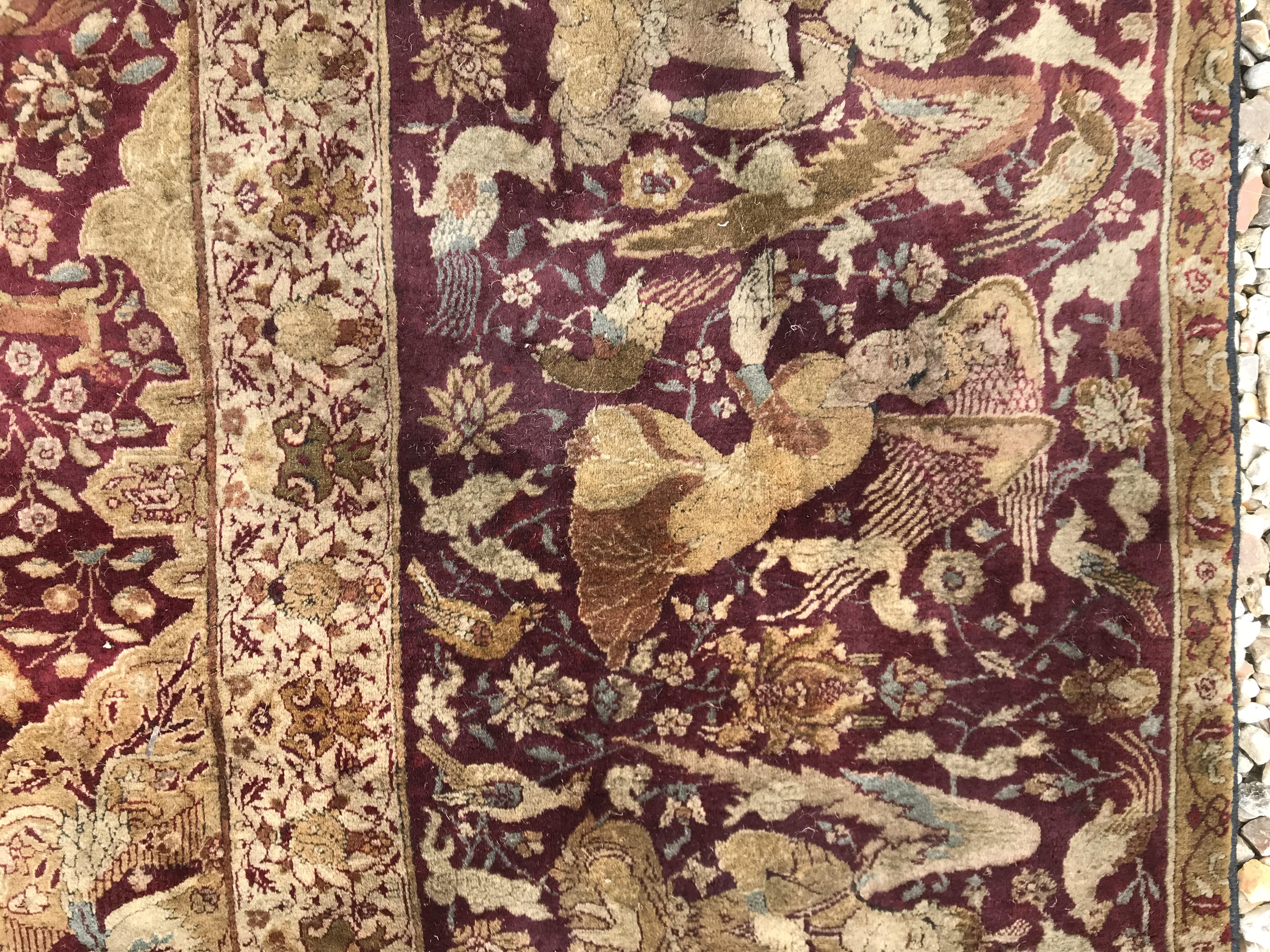 An early 20th Century Agra North India carpet with centre medallion on a wine-coloured ground, - Image 27 of 103