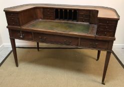 An early 20th Century mahogany Carlton House desk, the curved superstructure with various drawers,