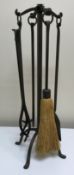 A modern Arts & Crafts style wrought iron fireside companion set,