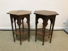 A near-matching pair of circa 1900 oak hexagonal two-tier occasional tables in the Liberty manner,