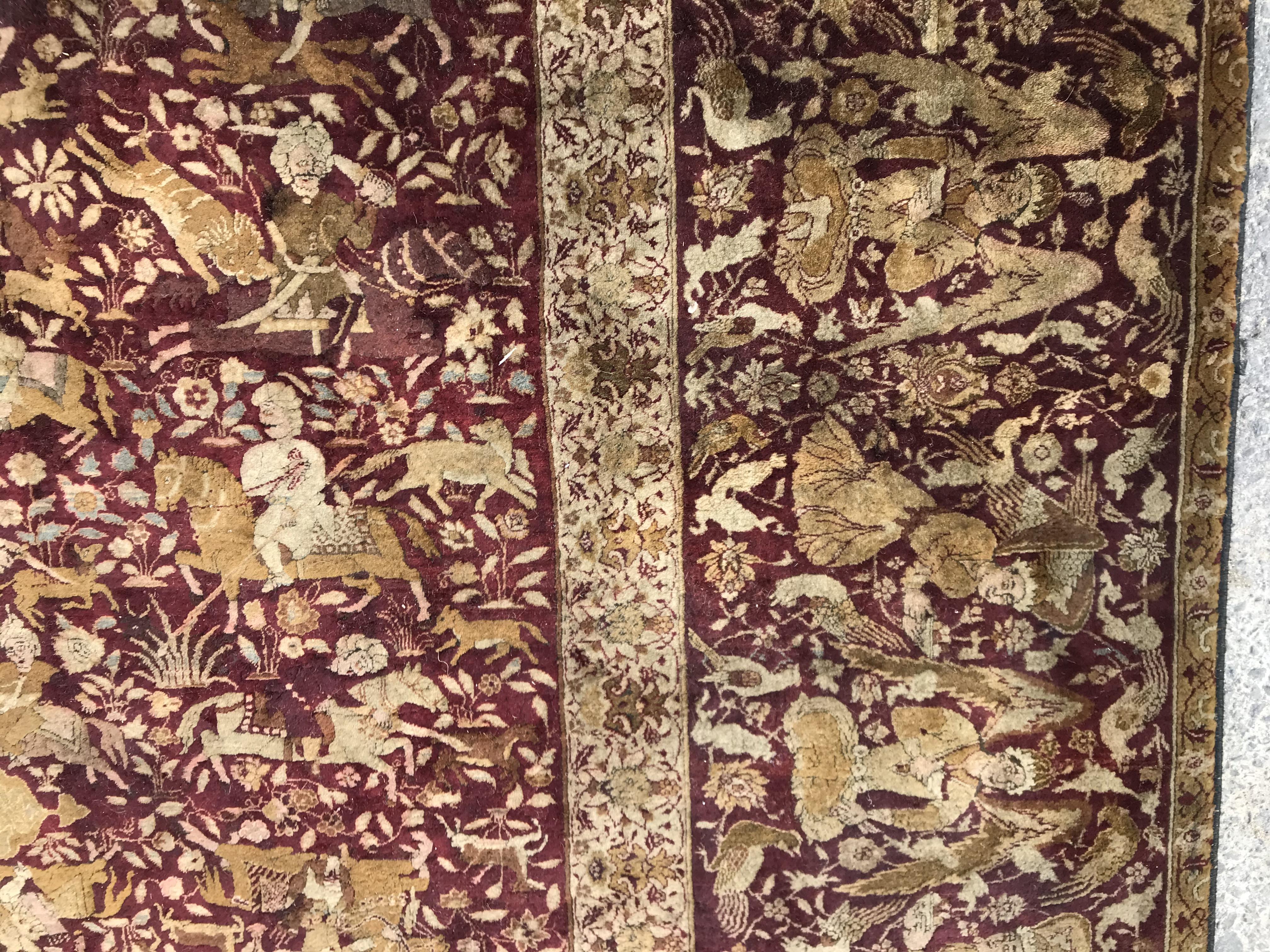 An early 20th Century Agra North India carpet with centre medallion on a wine-coloured ground, - Image 4 of 103