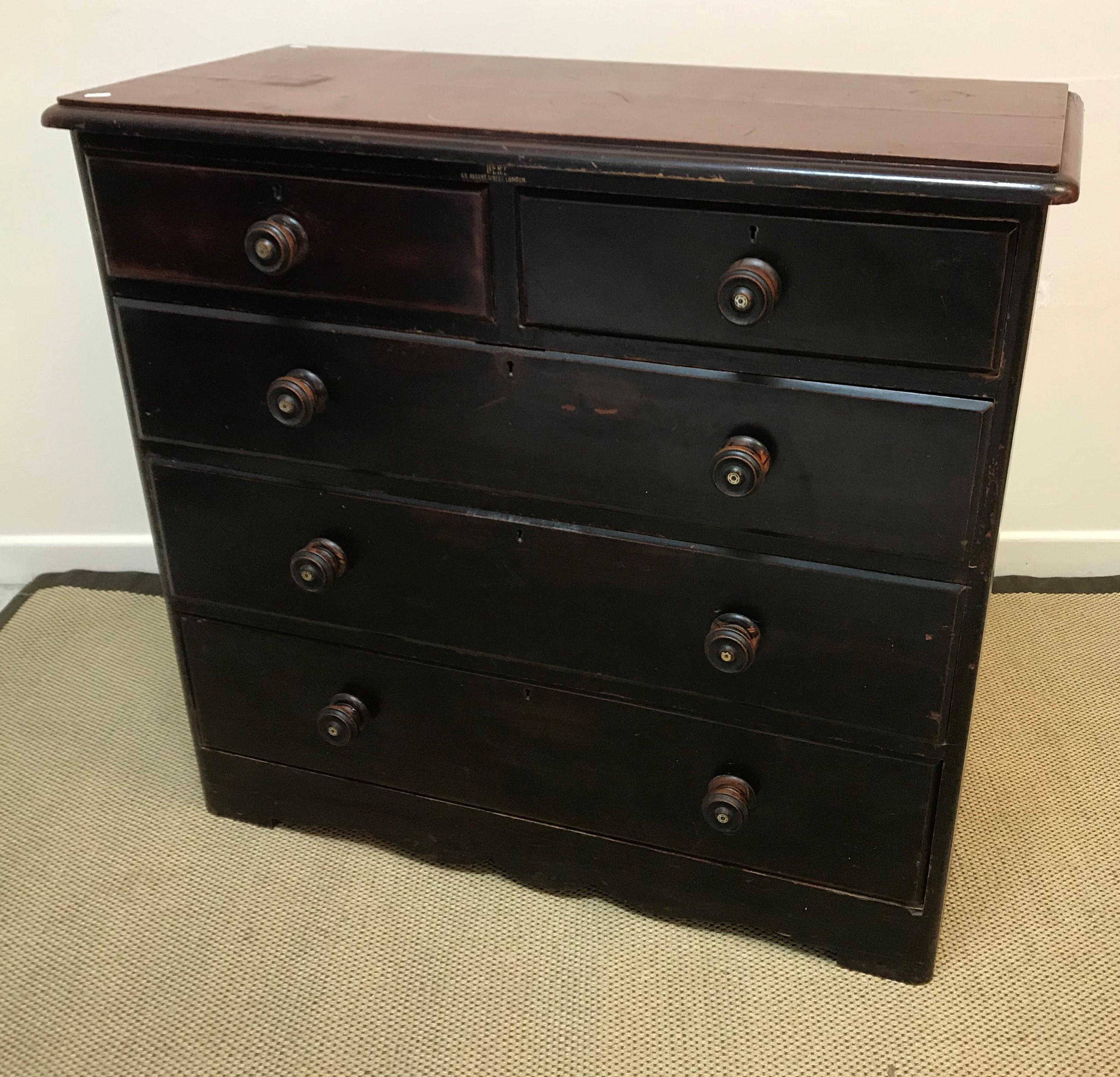 A Victorian mahogany veneered chest of two short and three long graduated drawers with ebonised and