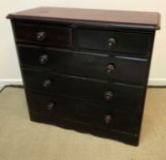 A Victorian mahogany veneered chest of two short and three long graduated drawers with ebonised and