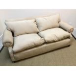 A circa 1900 fawn upholstered three-seat sofa on square tapered front legs (castors missing),
