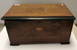 A 19th Century rosewood and inlaid cased music box with 3 bells in sight ,