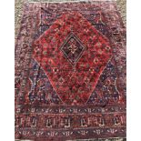 A Persian rug with all over floral decoration on a red ground,