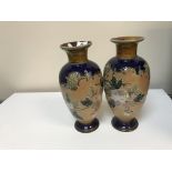 A pair of Doulton Lambeth stoneware vases each decorated with floral spray and stamped to base,
