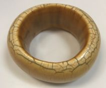 A 19th Century African ivory bangle of heavy proportions, 9.5 cm x 8.5 cm, 237.2 g, 7.