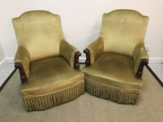 A pair of late 19th Century gold dralon upholstered carved walnut framed scroll arm chairs on
