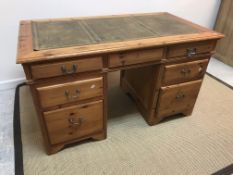 A modern pitch pine double pedestal desk,