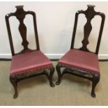 A pair of 18th Century walnut framed low chairs with scroll carved top rail and vase shaped back