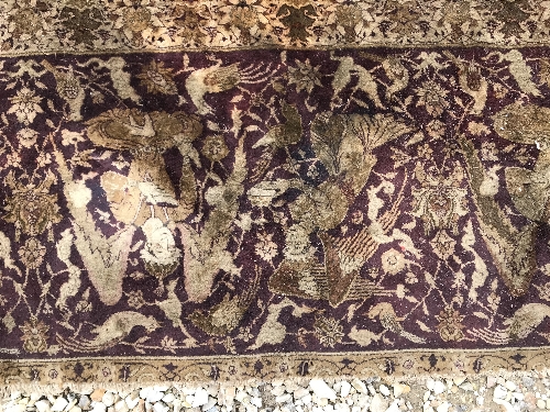 An early 20th Century Agra North India carpet with centre medallion on a wine-coloured ground, - Image 79 of 103