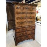 An early 18th Century walnut, feather and cross-banded chest on chest,