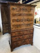 An early 18th Century walnut, feather and cross-banded chest on chest,