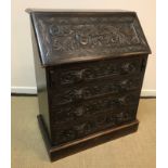 A late Victorian carved oak Gothic Revival bureau,