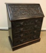 A late Victorian carved oak Gothic Revival bureau,