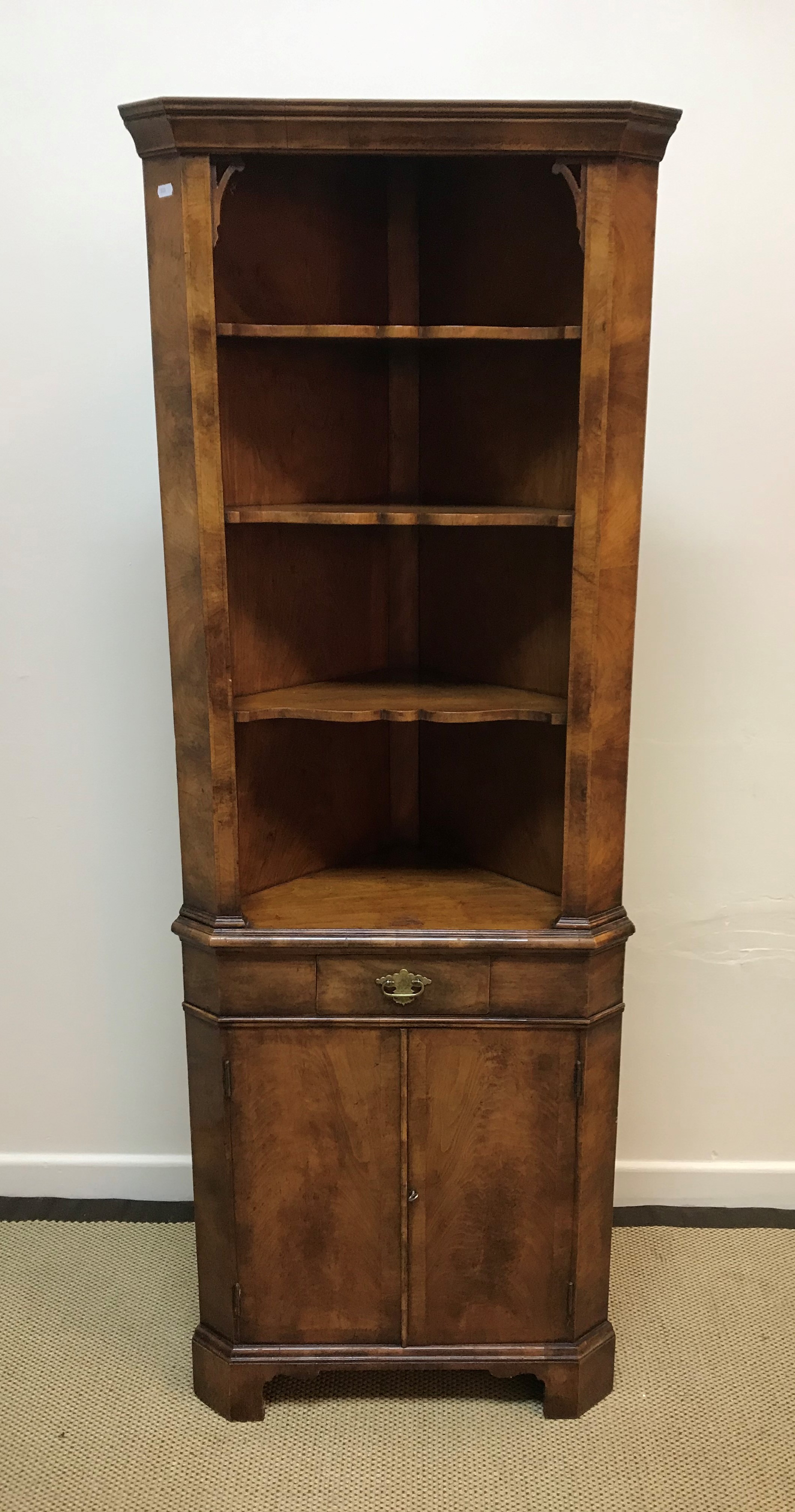 A 20th Century walnut freestanding corner cupboard of small proportions in the 18th Century style,