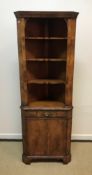 A 20th Century walnut freestanding corner cupboard of small proportions in the 18th Century style,