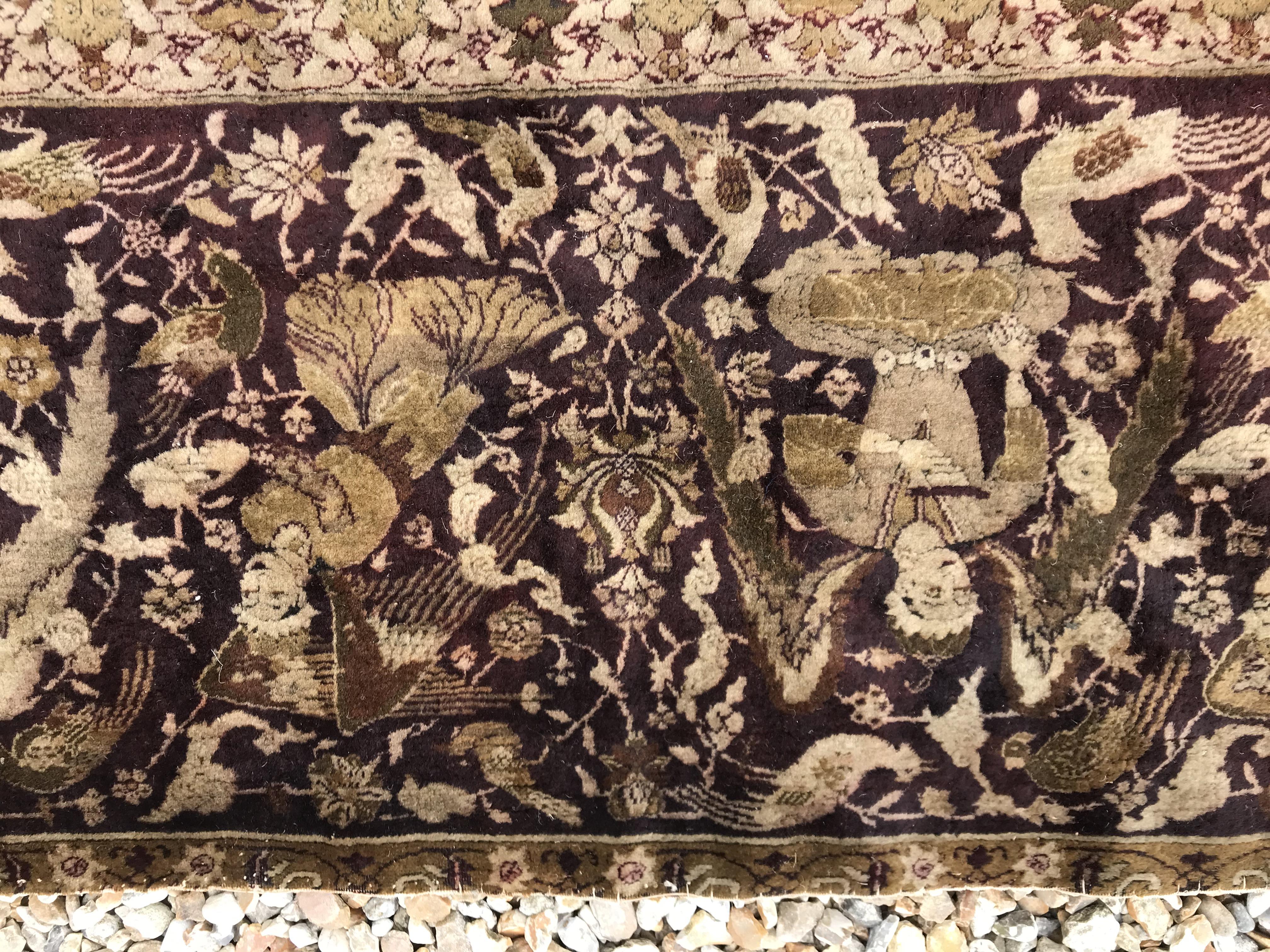 An early 20th Century Agra North India carpet with centre medallion on a wine-coloured ground, - Image 15 of 103