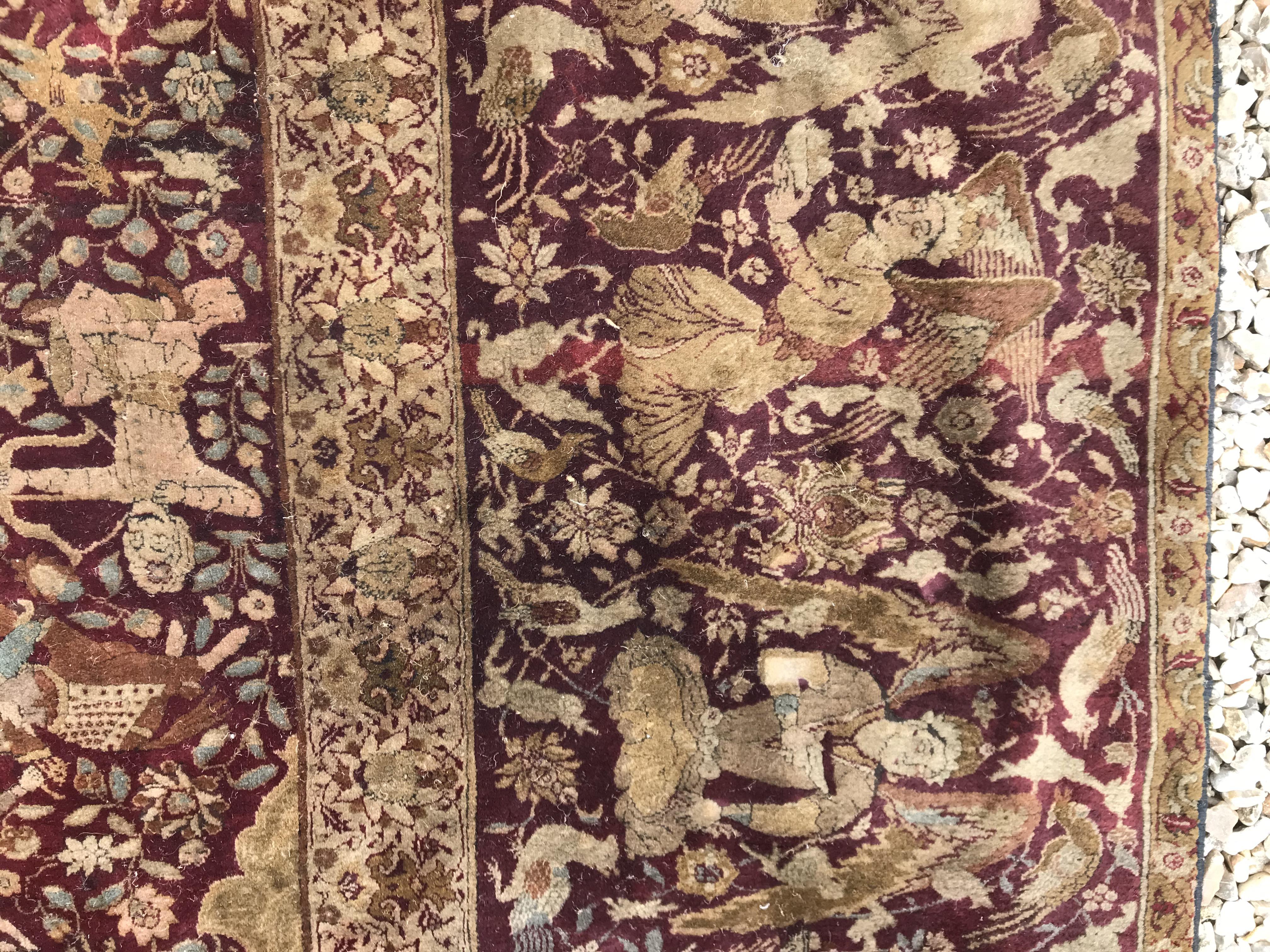 An early 20th Century Agra North India carpet with centre medallion on a wine-coloured ground, - Image 38 of 103