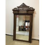 A mahogany framed pier glass with ornate foliate and floral decorated surmount over a rectangular