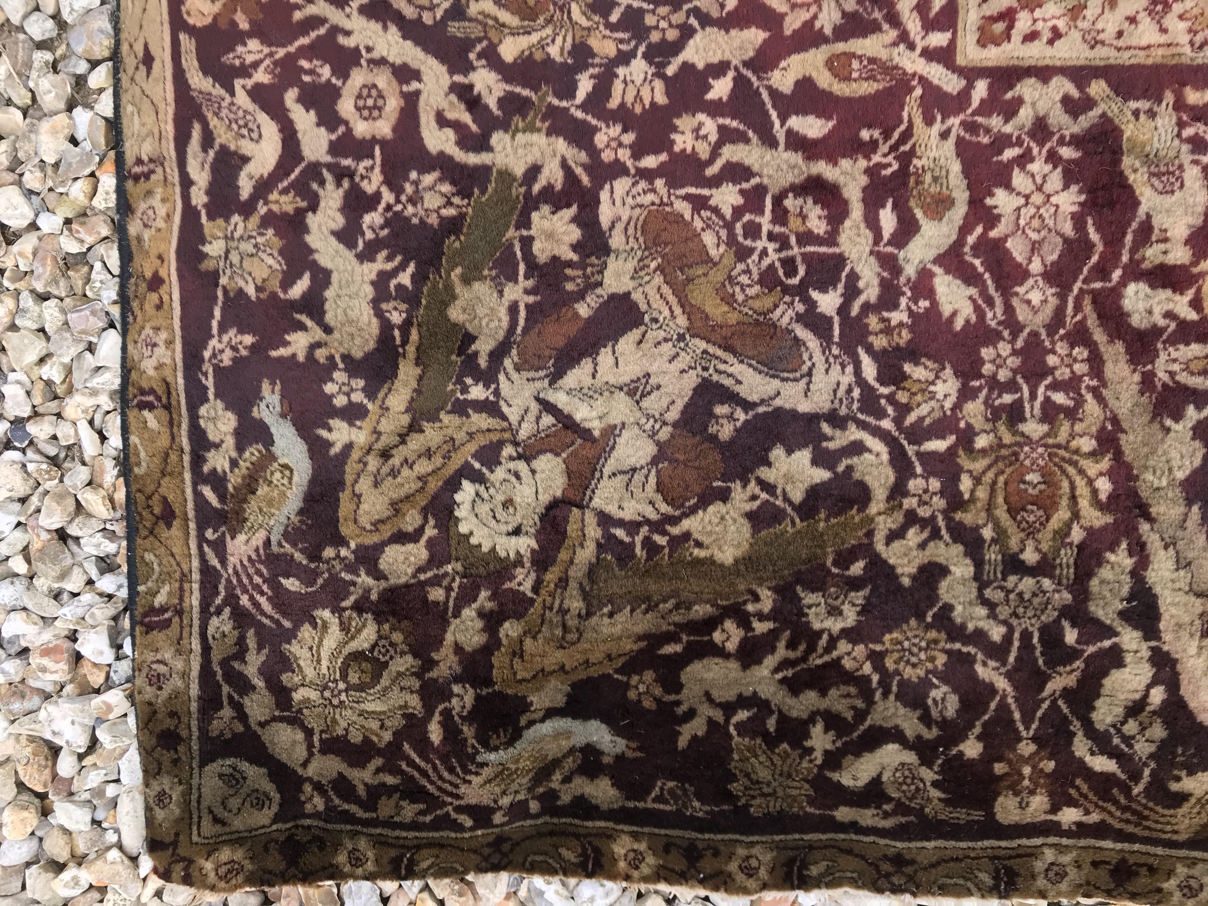 An early 20th Century Agra North India carpet with centre medallion on a wine-coloured ground, - Image 19 of 103