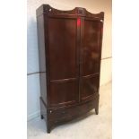 An Edwardian mahogany bow fronted two door wardrobe with single drawer on bracket feet,