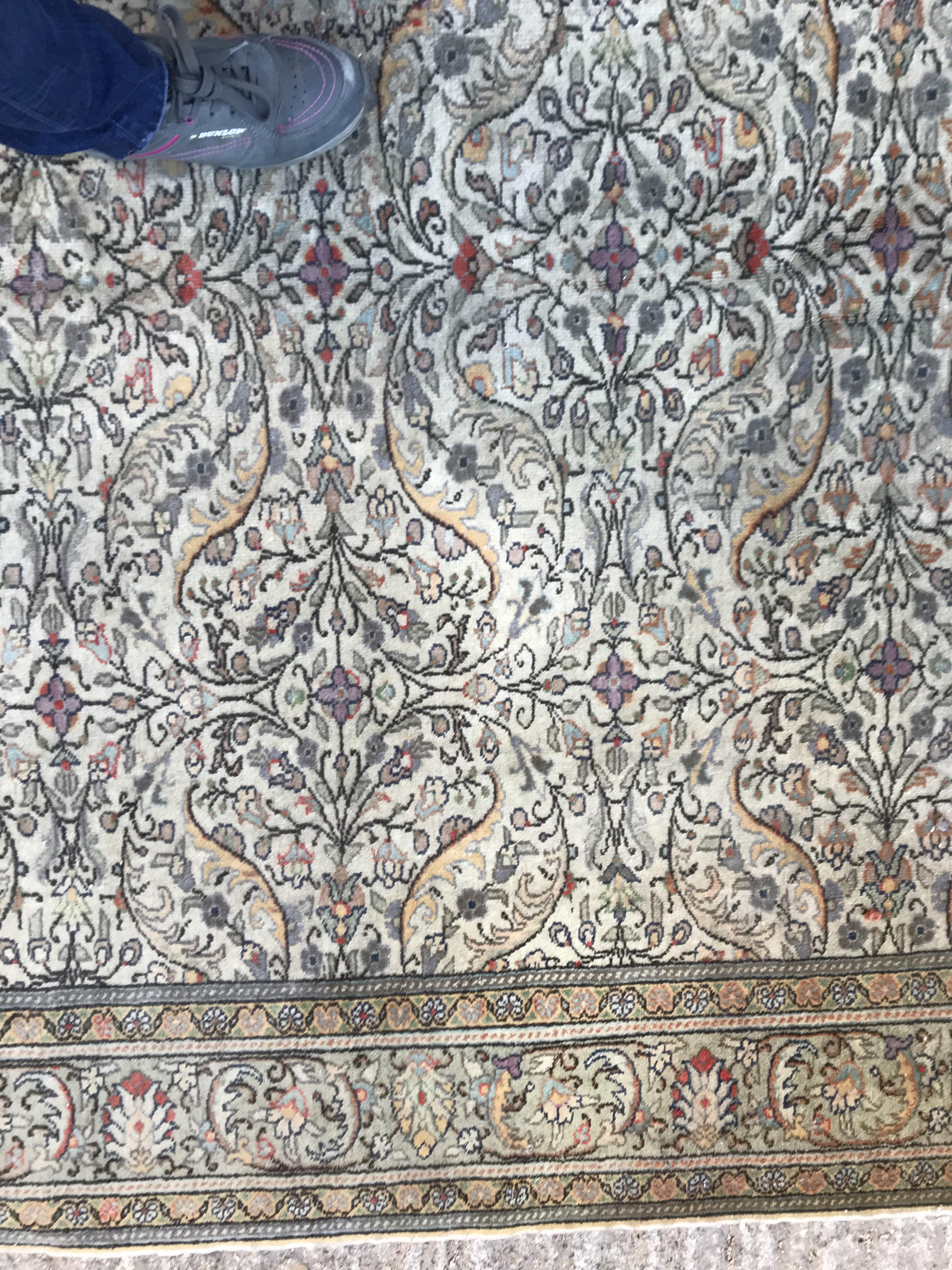 An Oriental carpet, the central panel set with all over floral decoration on a fawn ground, - Image 3 of 11