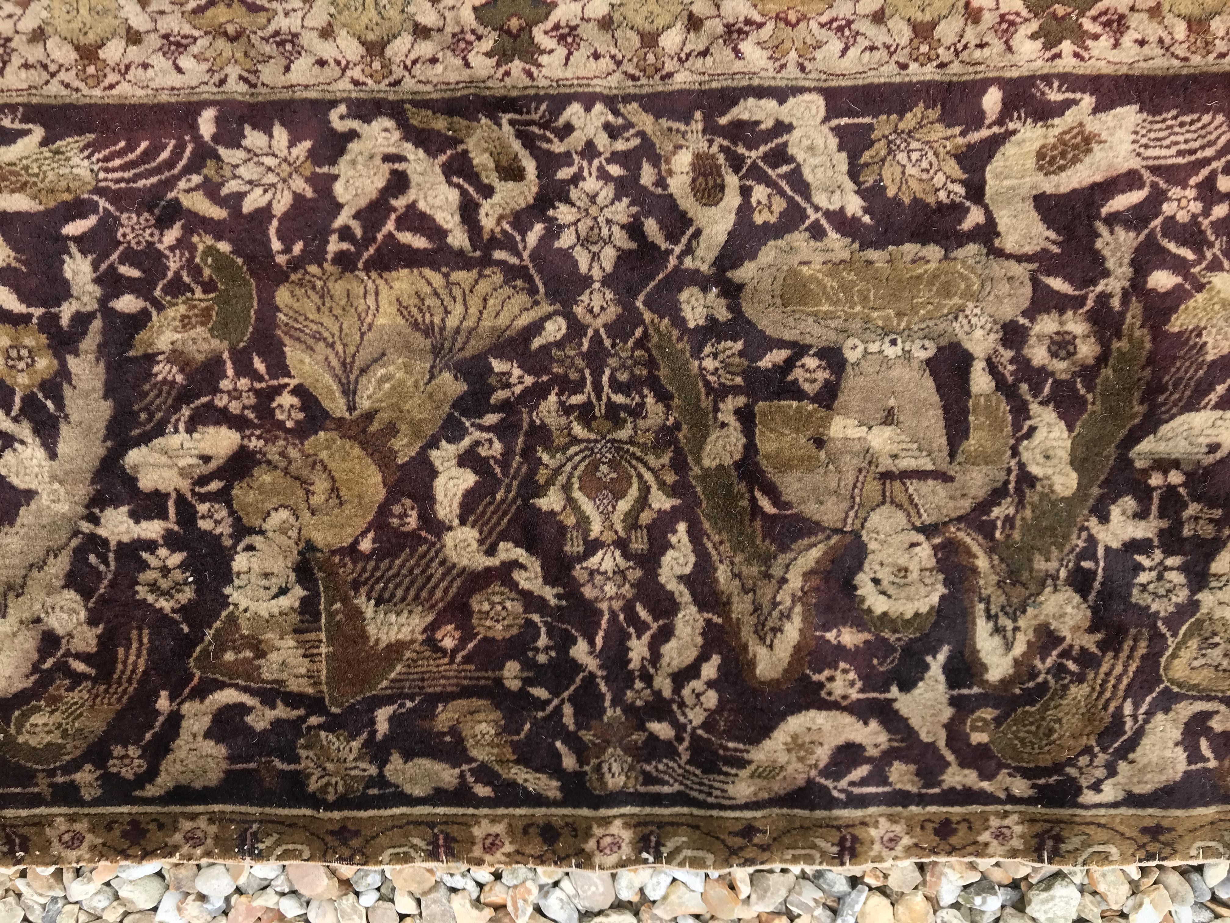 An early 20th Century Agra North India carpet with centre medallion on a wine-coloured ground, - Image 16 of 103