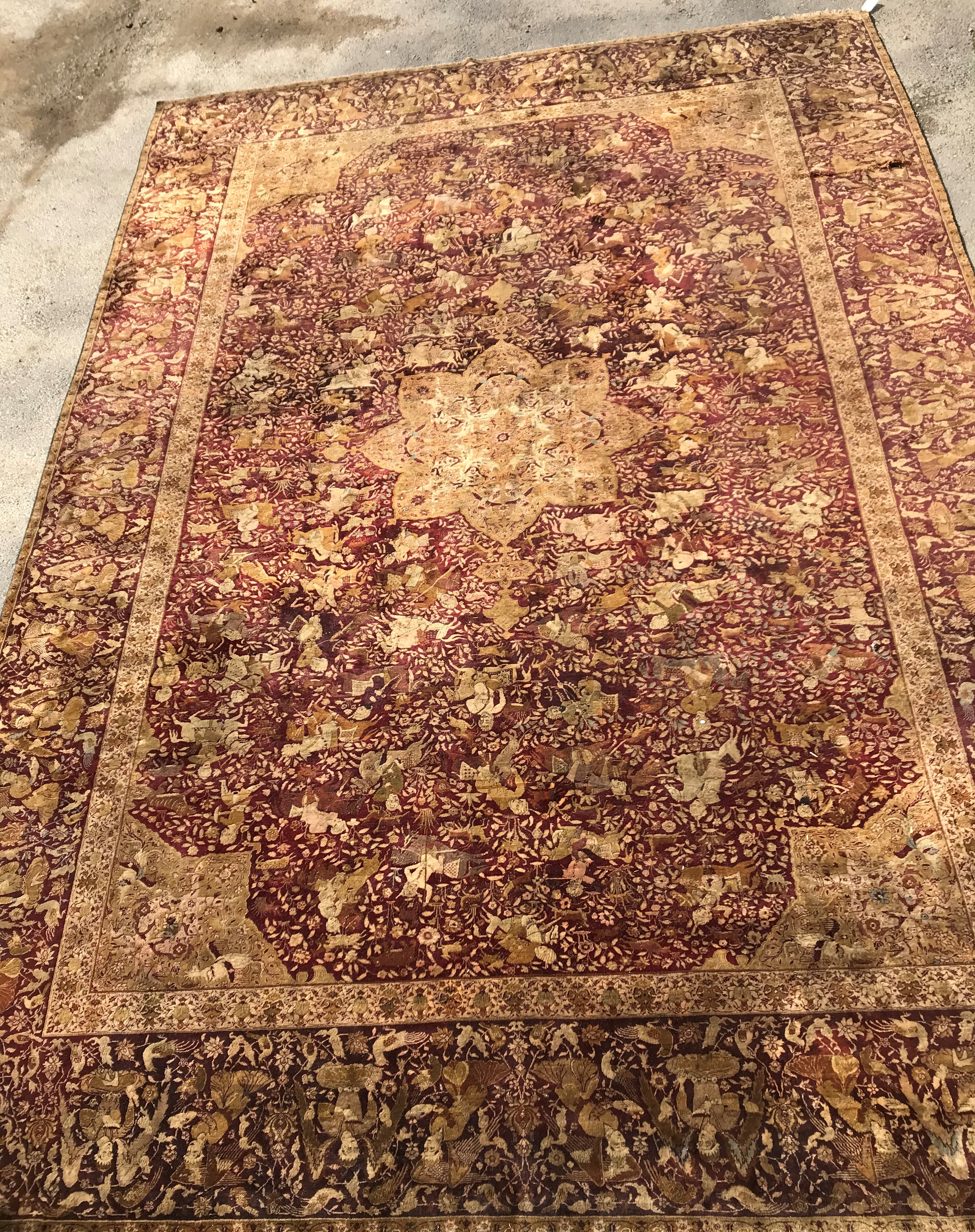 An early 20th Century Agra North India carpet with centre medallion on a wine-coloured ground,