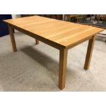 A modern light oak rectangular extending dining table on square supports (retailed be Lee Longland)