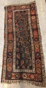 A Caucasian rug, the central panel set with repeating hook motif on a dark ground,