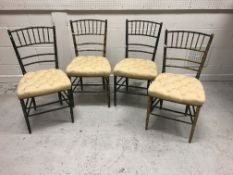 A set of four painted/gilded simulated bamboo framed chairs with buttoned upholstered seats,