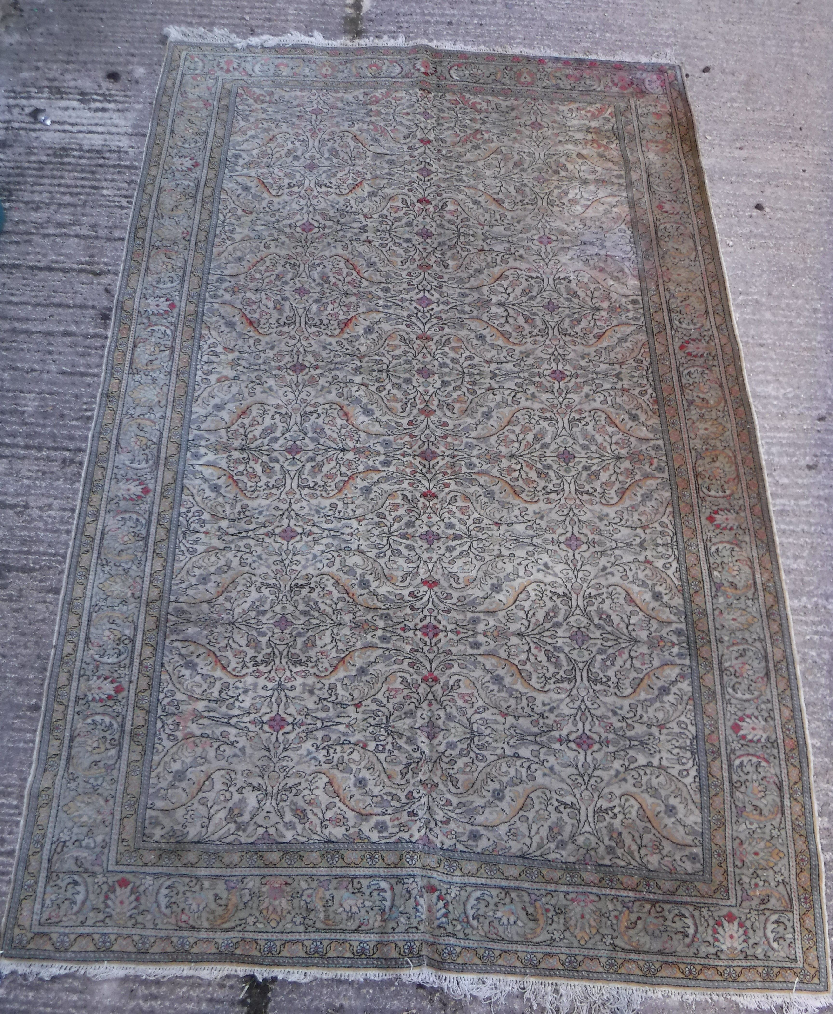 An Oriental carpet, the central panel set with all over floral decoration on a fawn ground, - Image 10 of 11